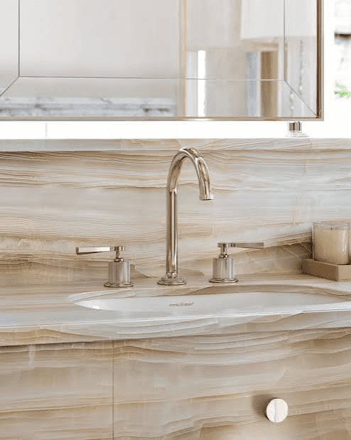 Detailed bathroom sink with stone surfaces and polished fixtures